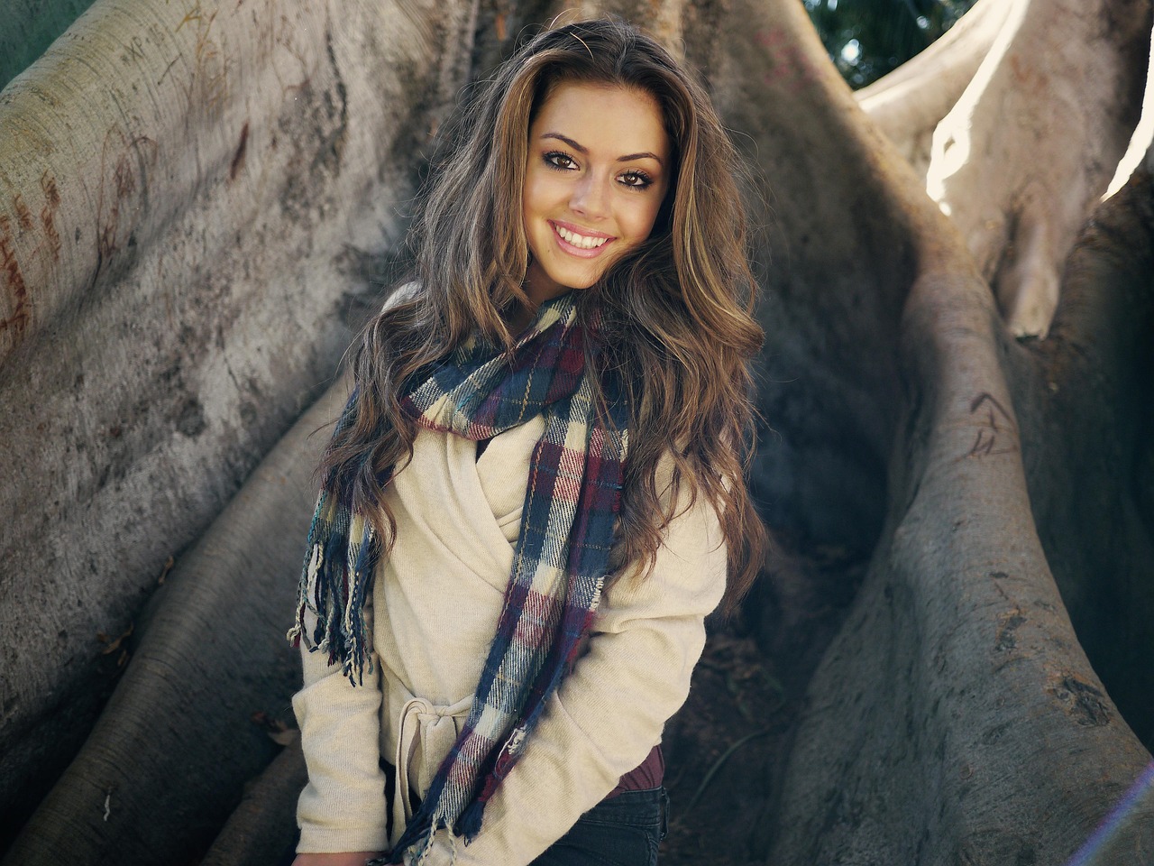 Woman in a cream jumper and checked scarf