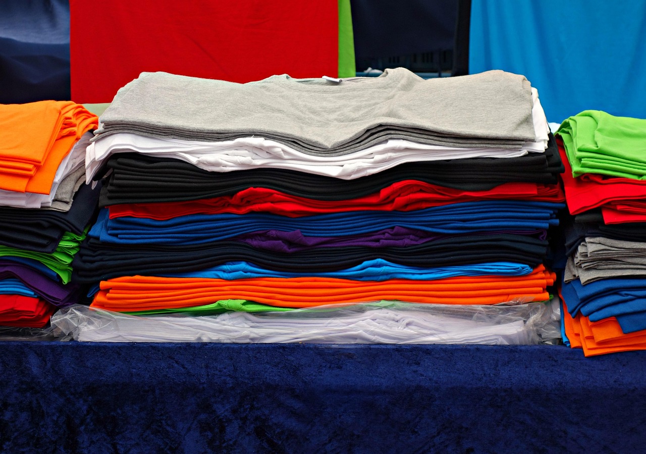 Stacks of folded T-shirts in many colours
