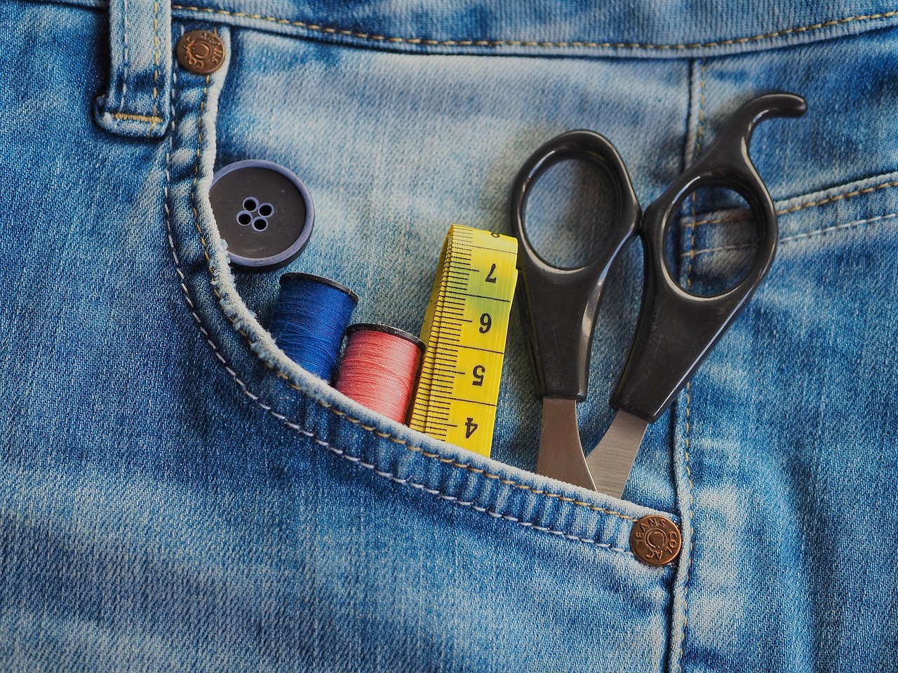 Tape measure and scissors in a denim pocket